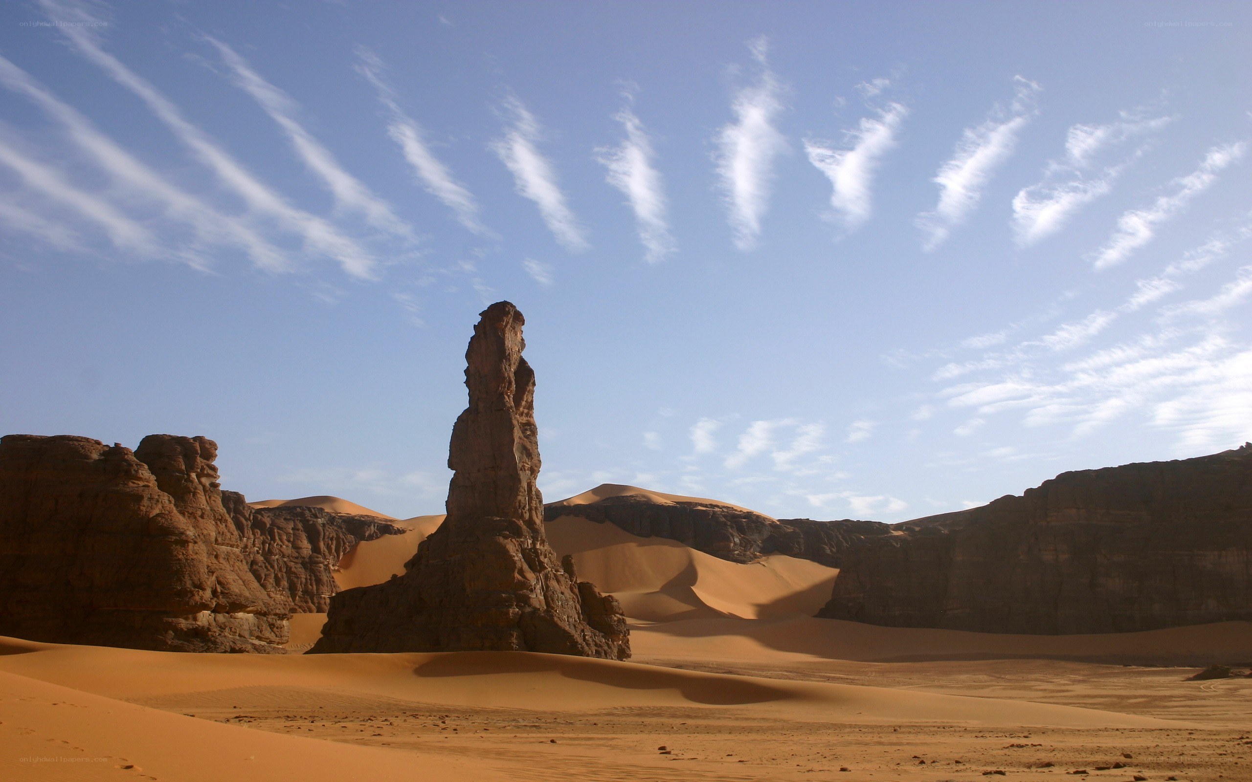 Desert rock formation under blue sky