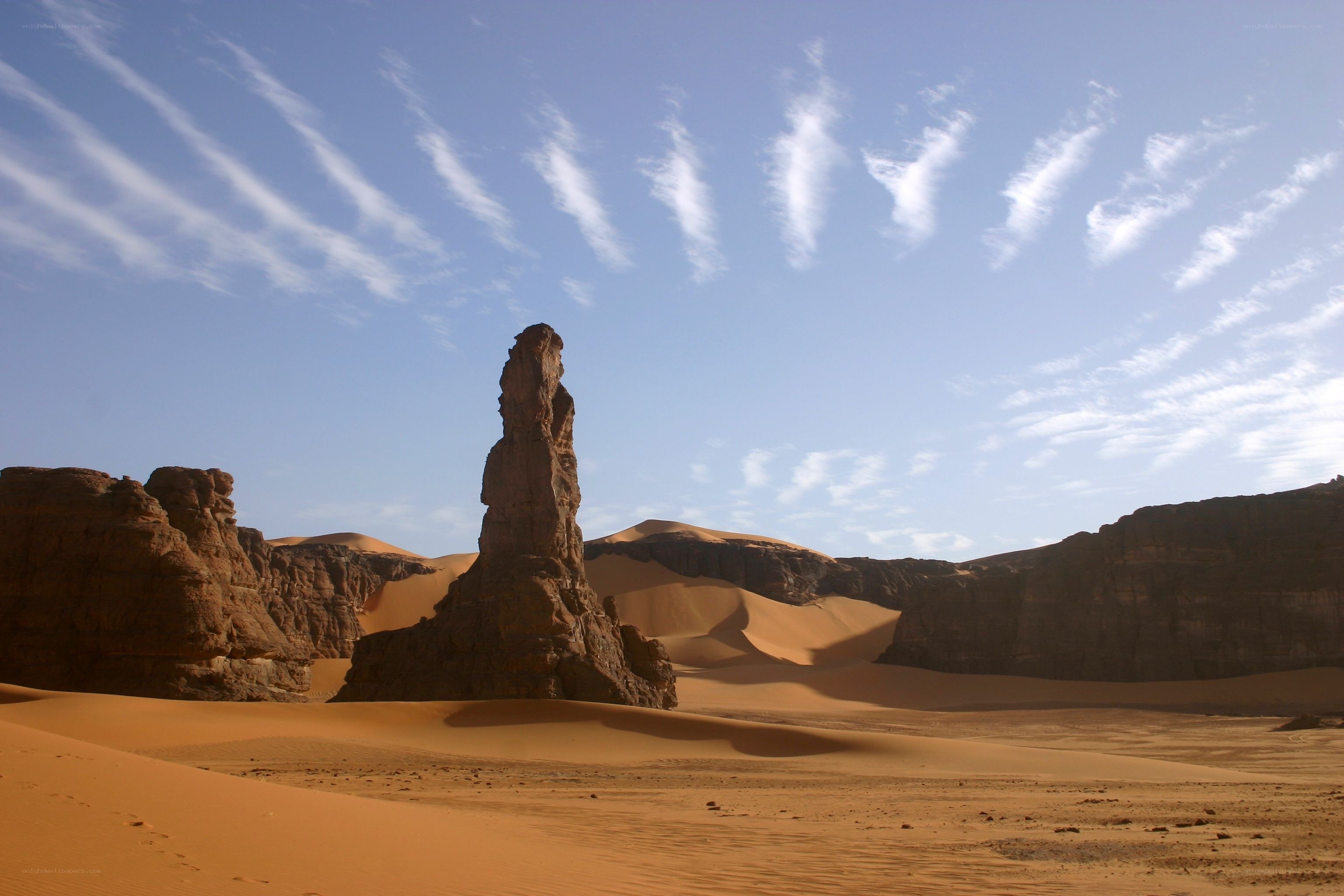 Desert rock formation under blue sky