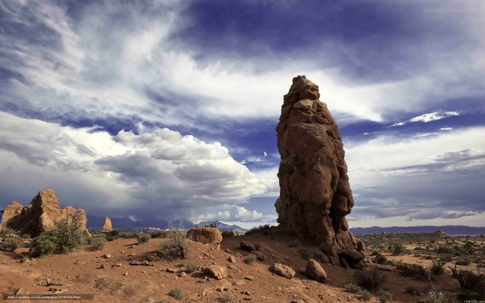 Desert rock formation under cloudy sky