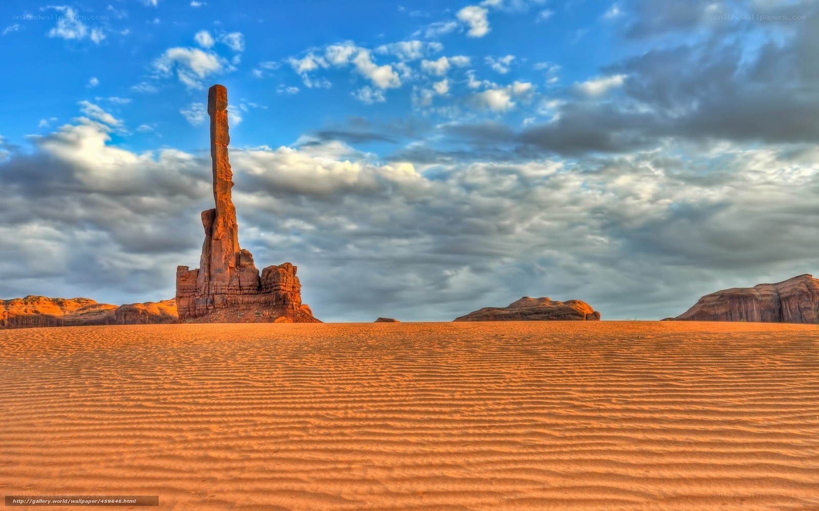 Desert rock formation under cloudy sky