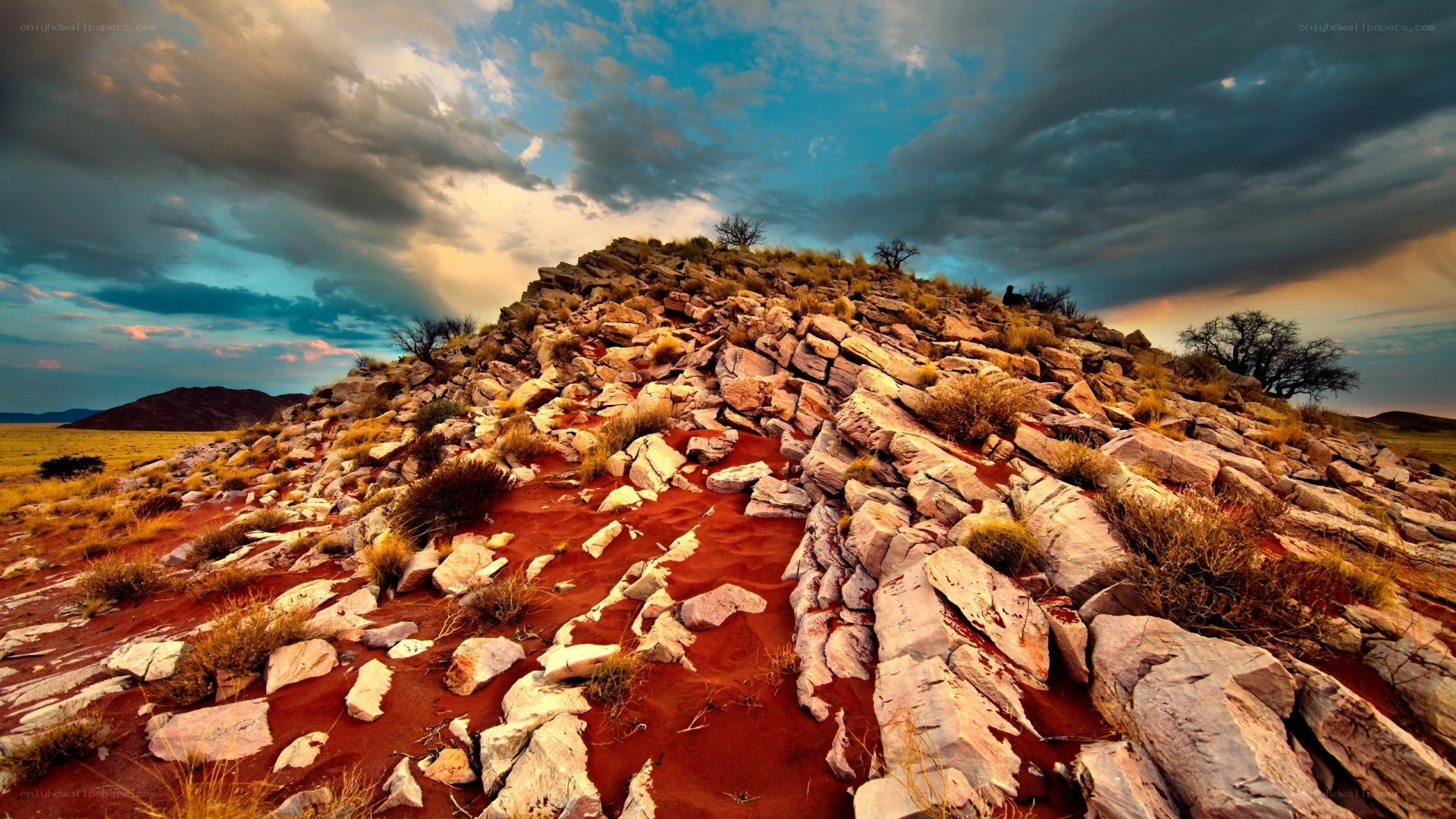 Desert rock formation under stormy sky