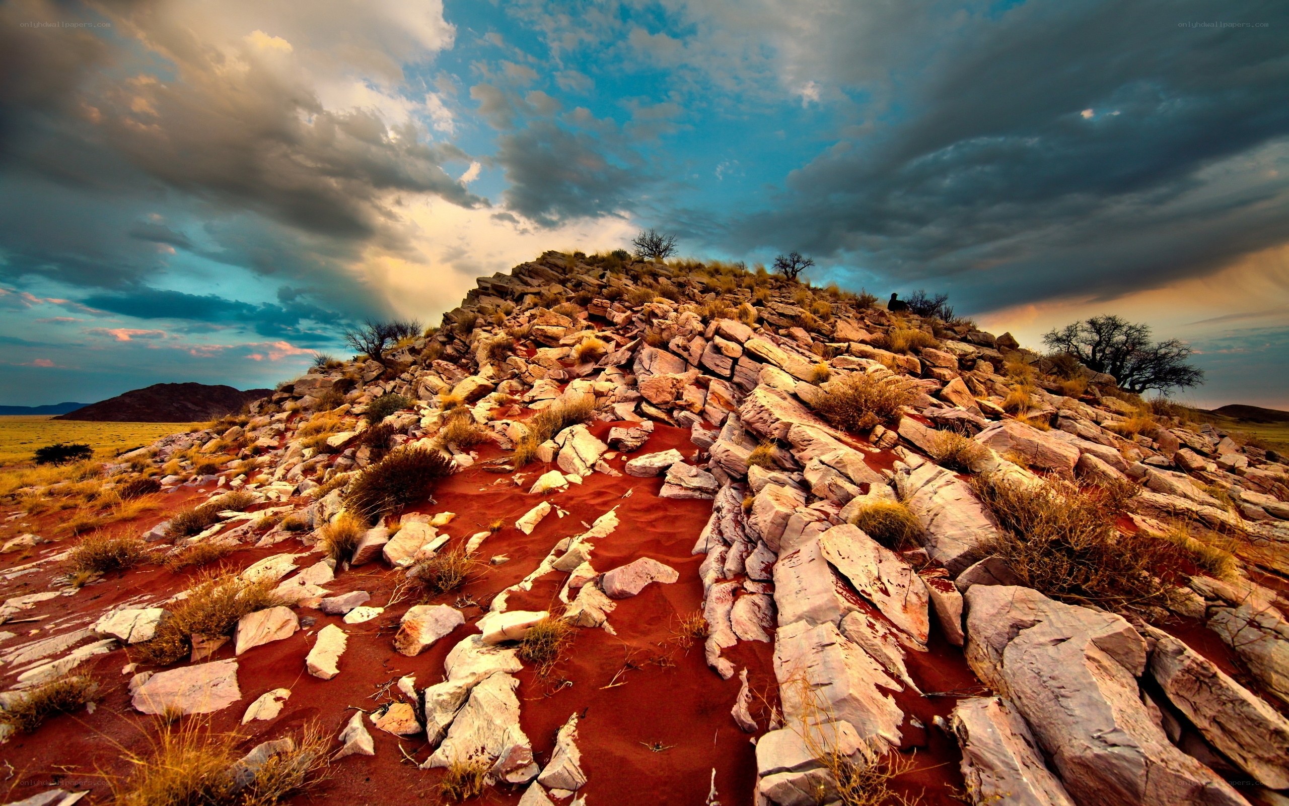 Desert rock formation under stormy sky