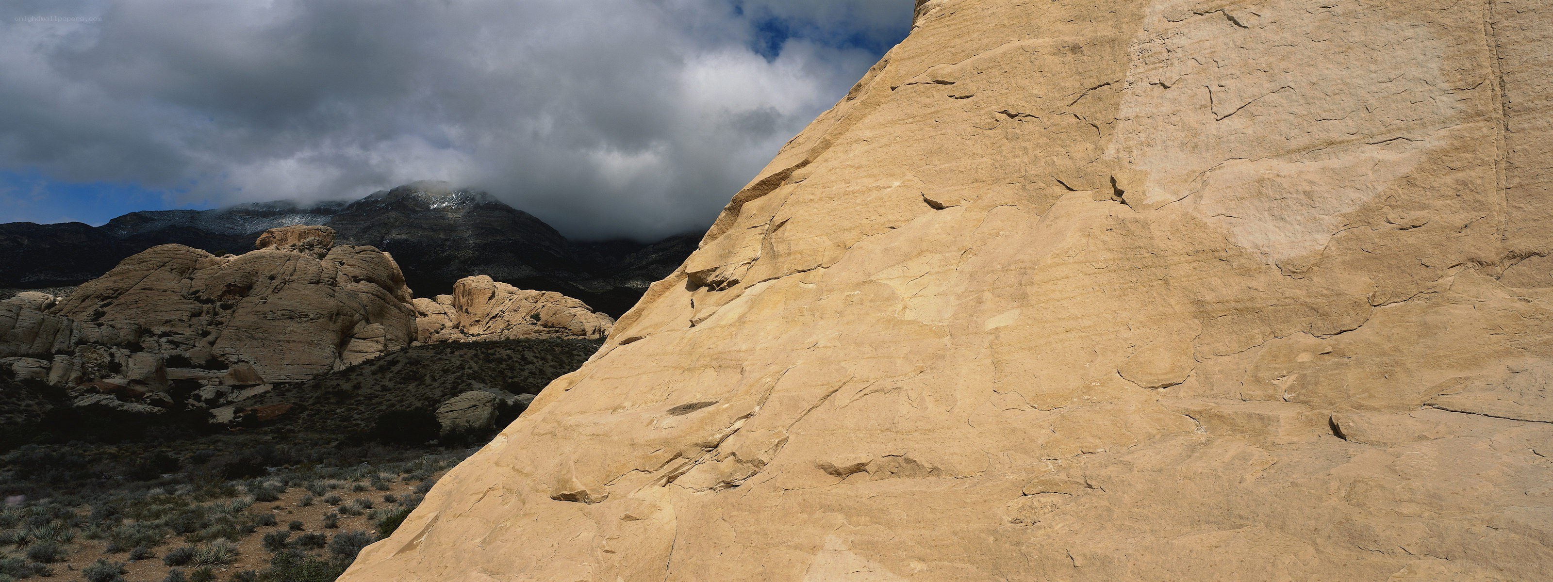 Desert rock formations under cloudy sky