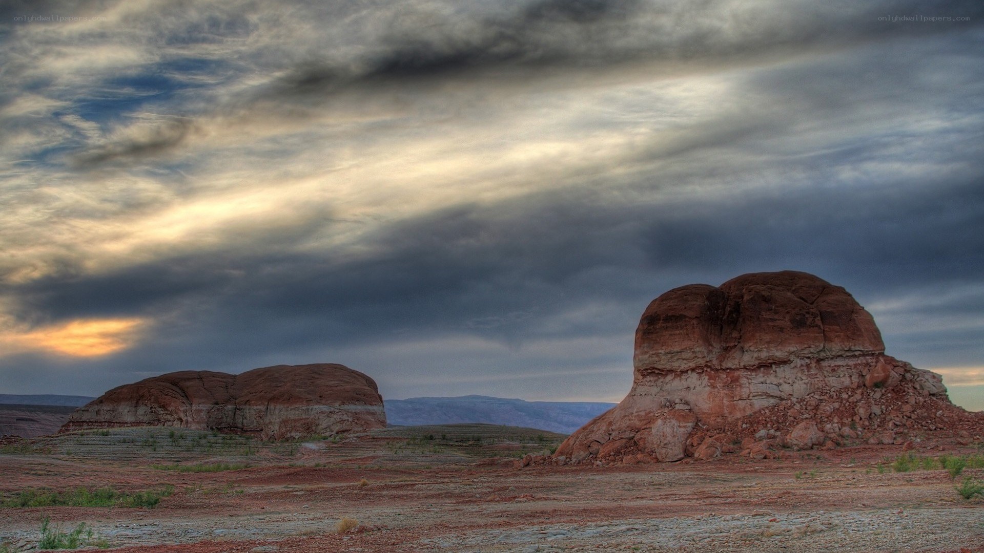 Desert rock formations under cloudy sky