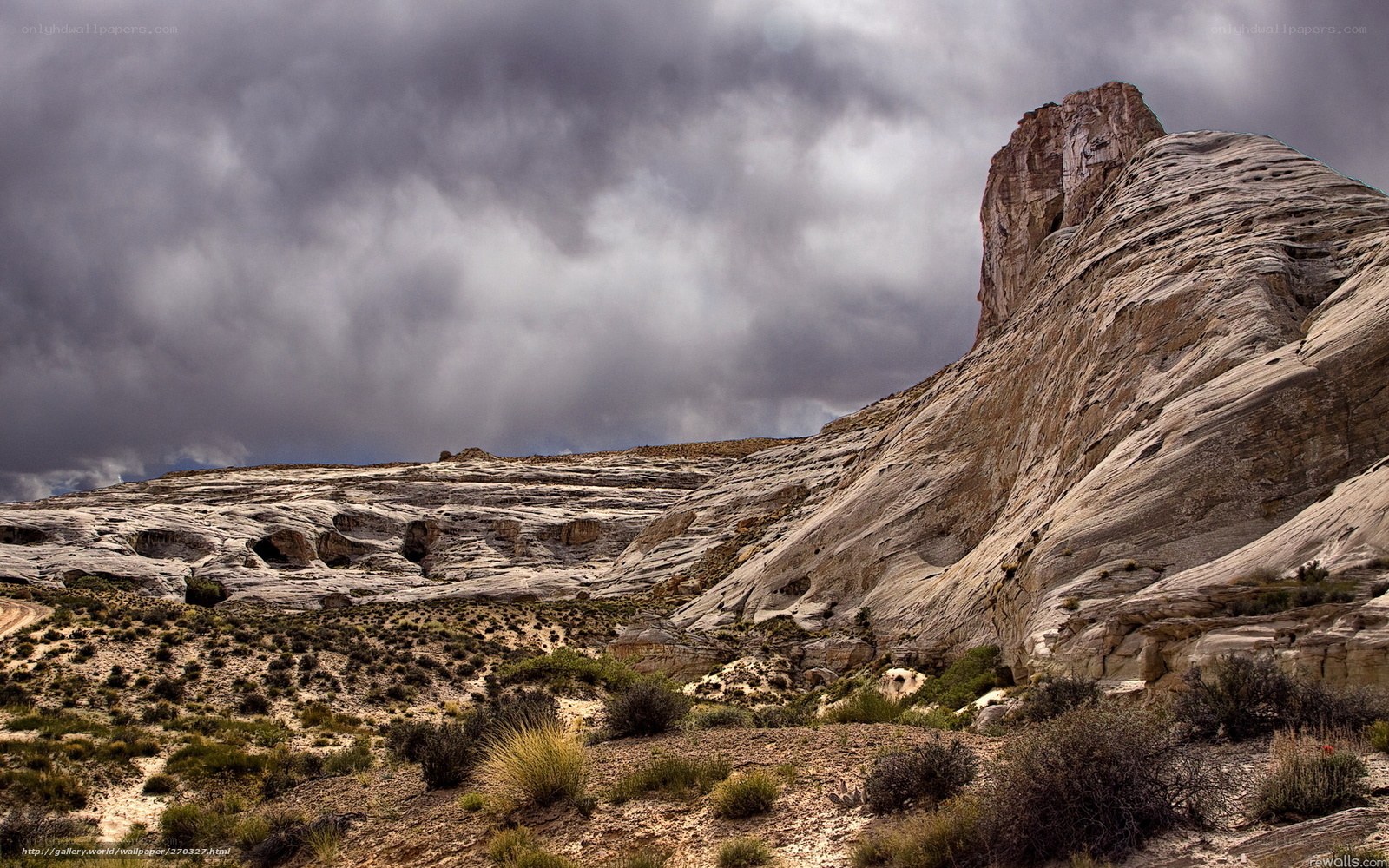 Desert rock formations under stormy sky