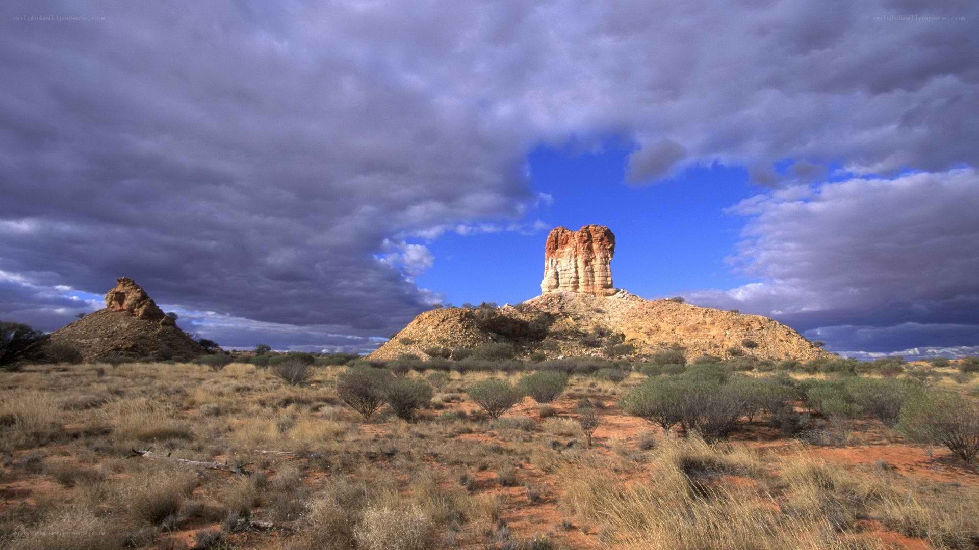 Desert rock formations under stormy sky