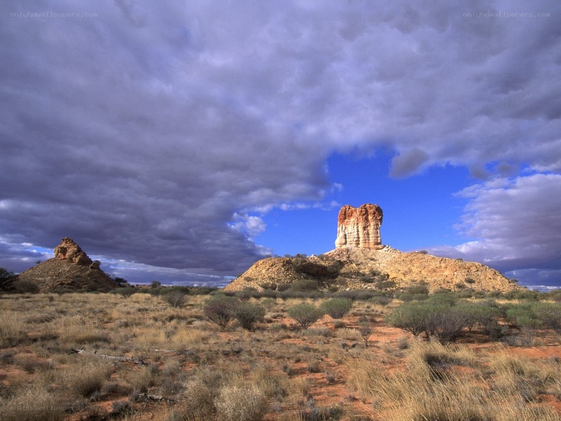 Desert rock formations under stormy sky