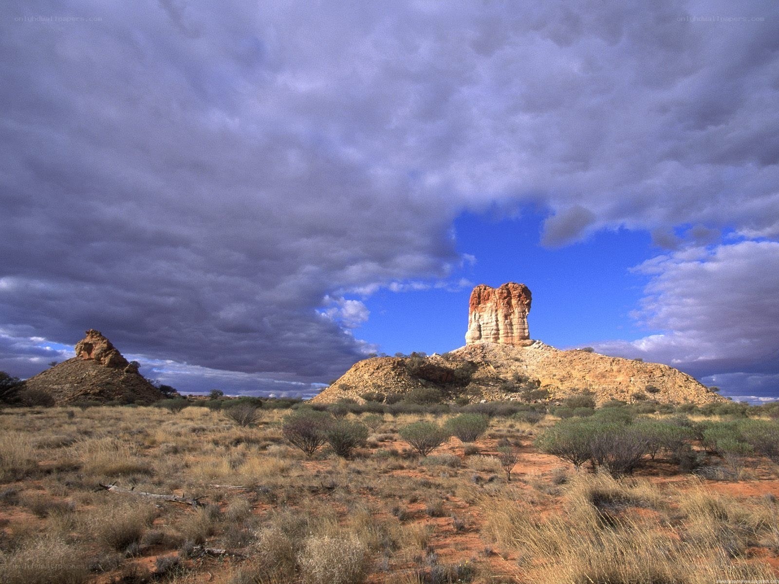 Desert rock formations under stormy sky