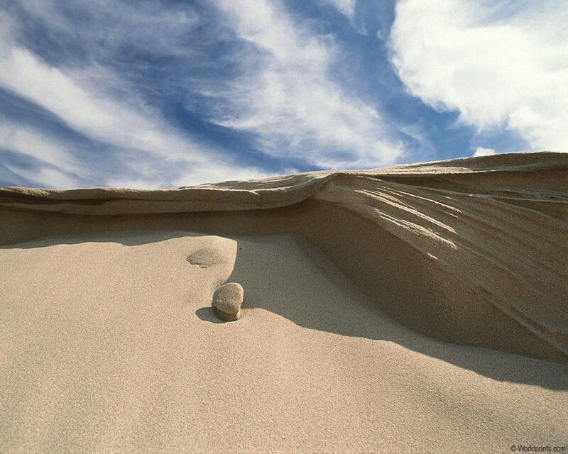 Desert sand dune with rock