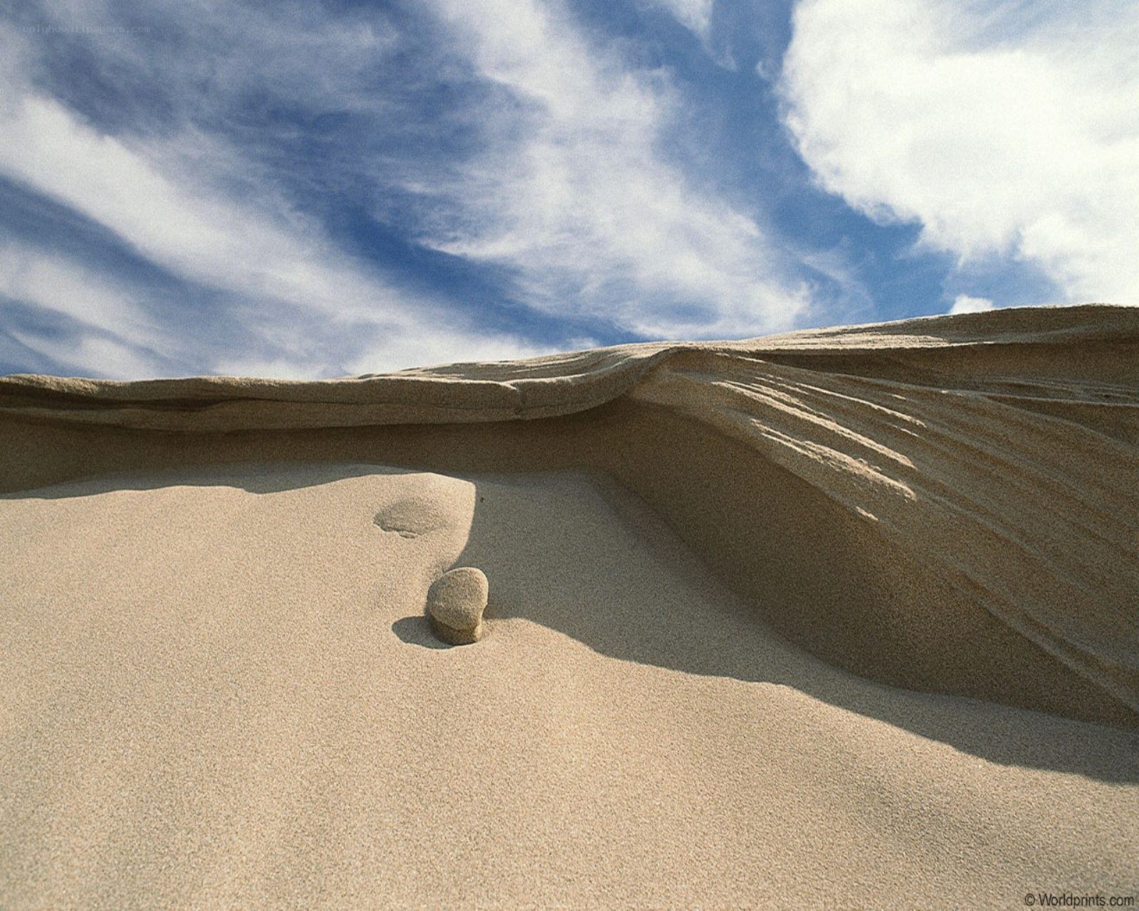 Desert sand dune with rock
