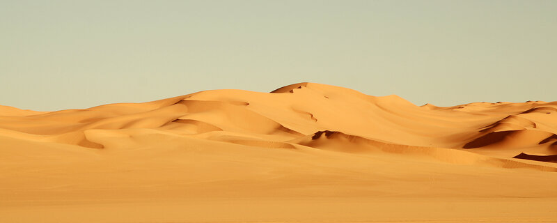 Desert sand dunes at sunset