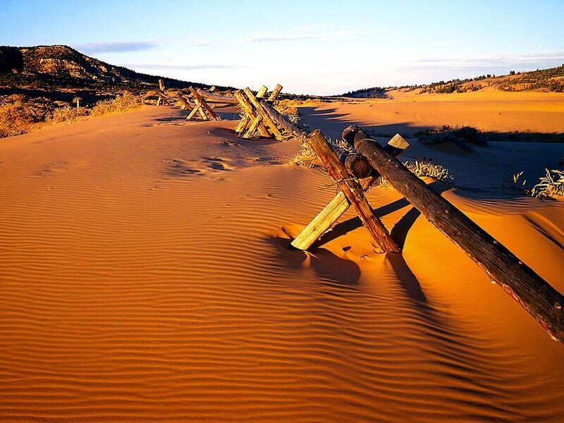 Desert sand dunes with wooden fence