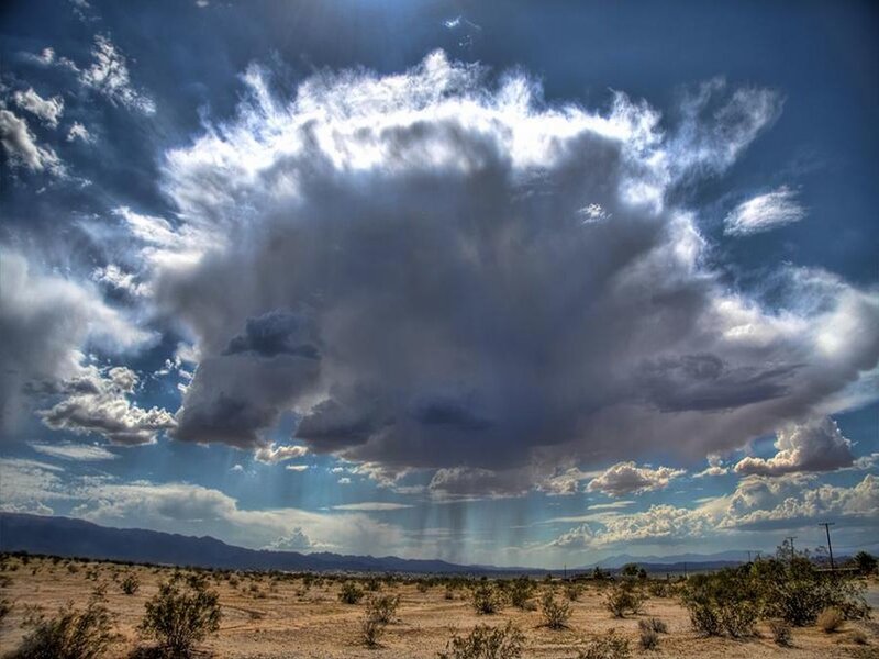 Desert storm with rain shafts