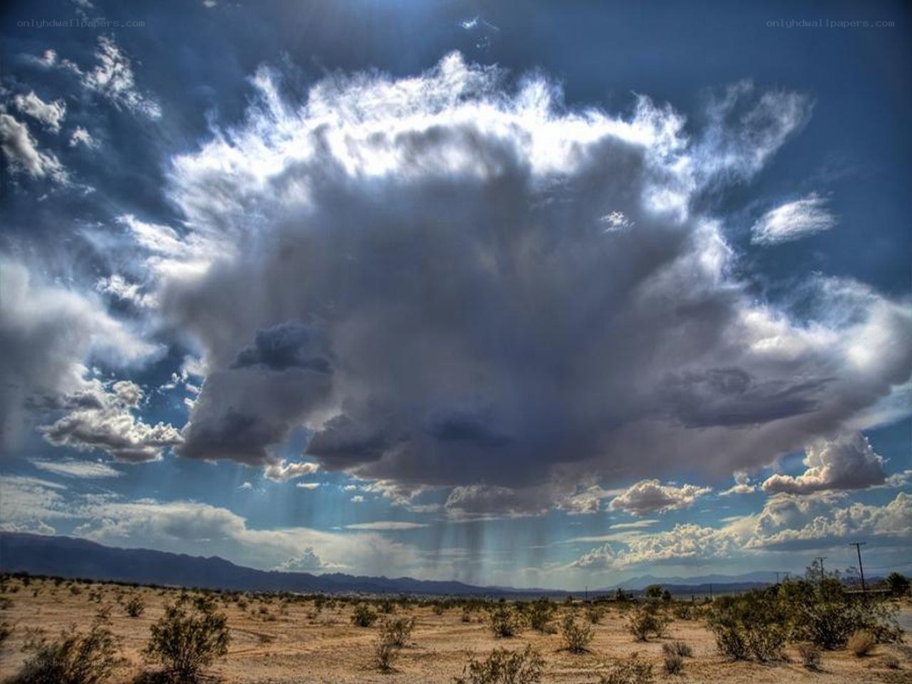 Desert storm with rain shafts