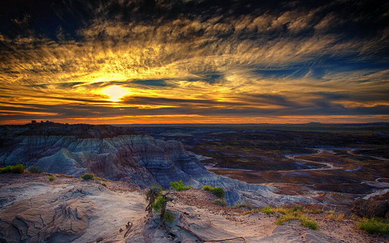 Desert sunset over layered cliffs