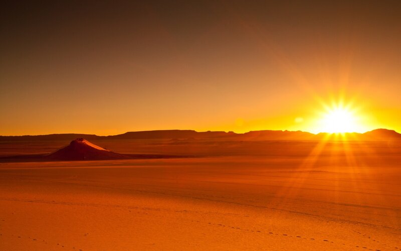 Desert sunset with sunburst