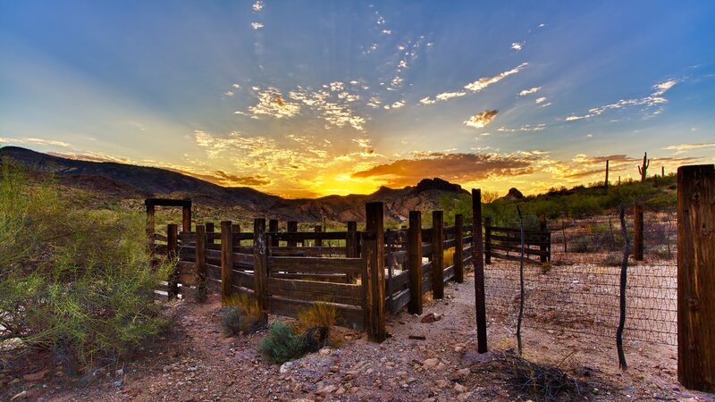 Desert sunset with wooden fence