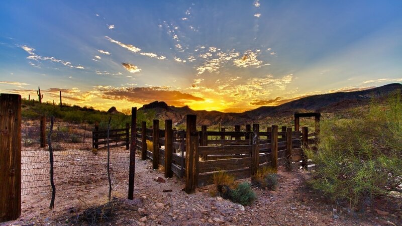 Desert sunset with wooden fence