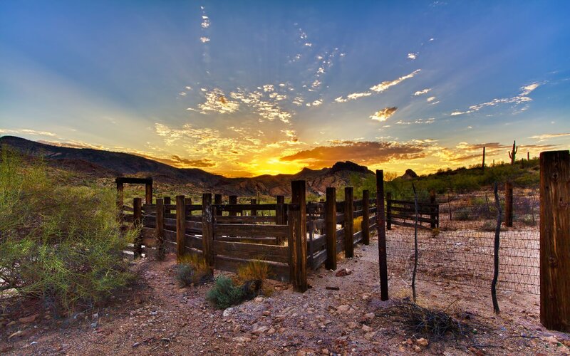 Desert sunset with wooden fence