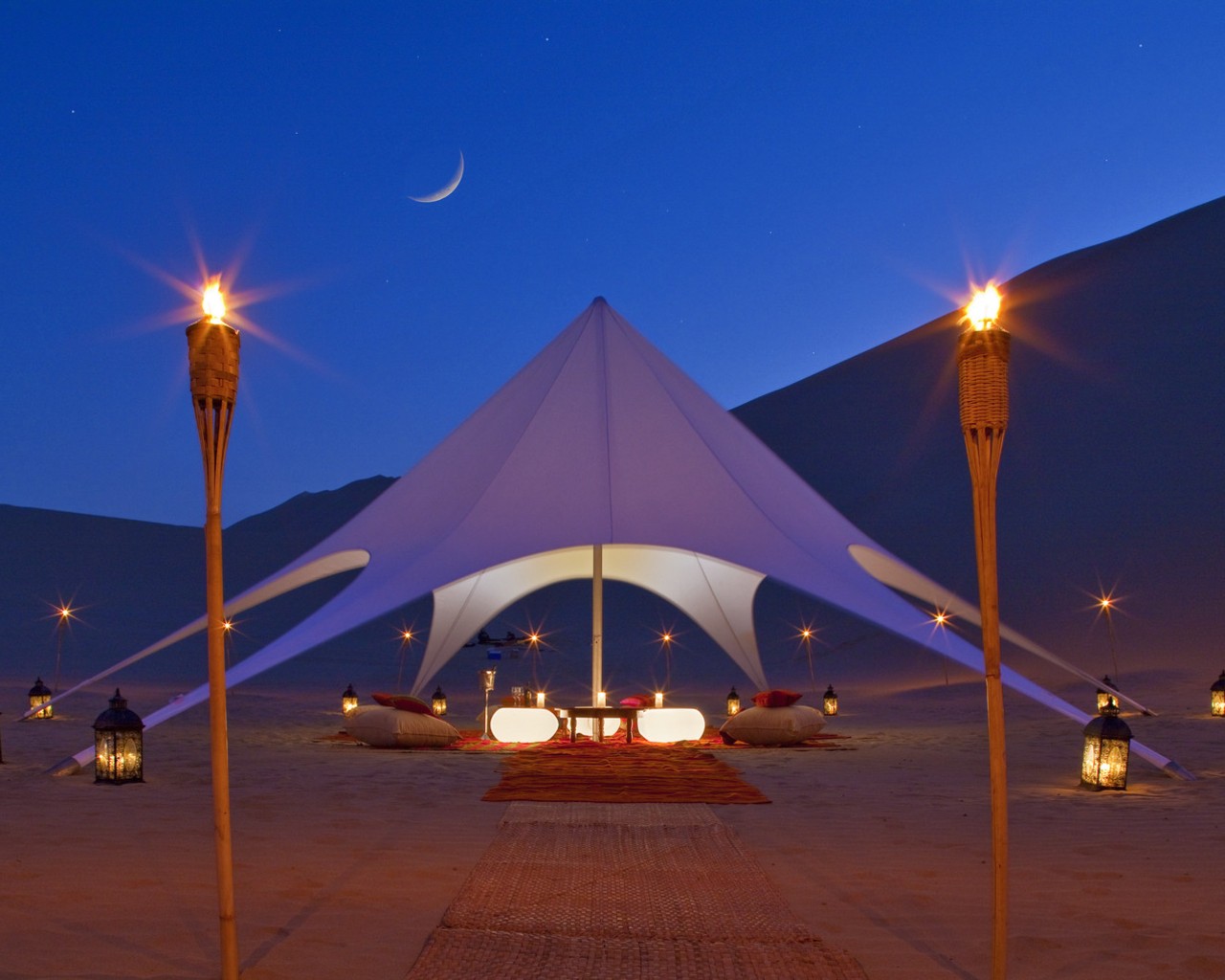 Desert tent under moonlight