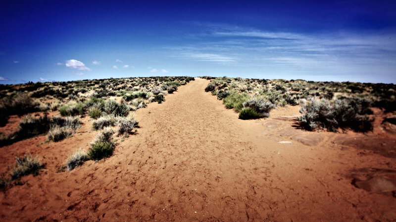 Desert trail under blue sky