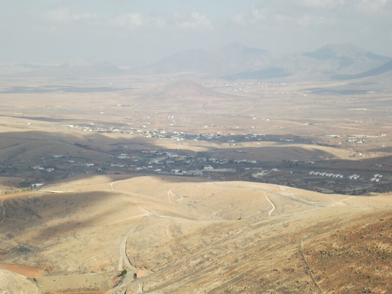 Desert valley with distant town