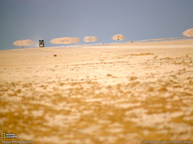 Desert vehicle with dust clouds