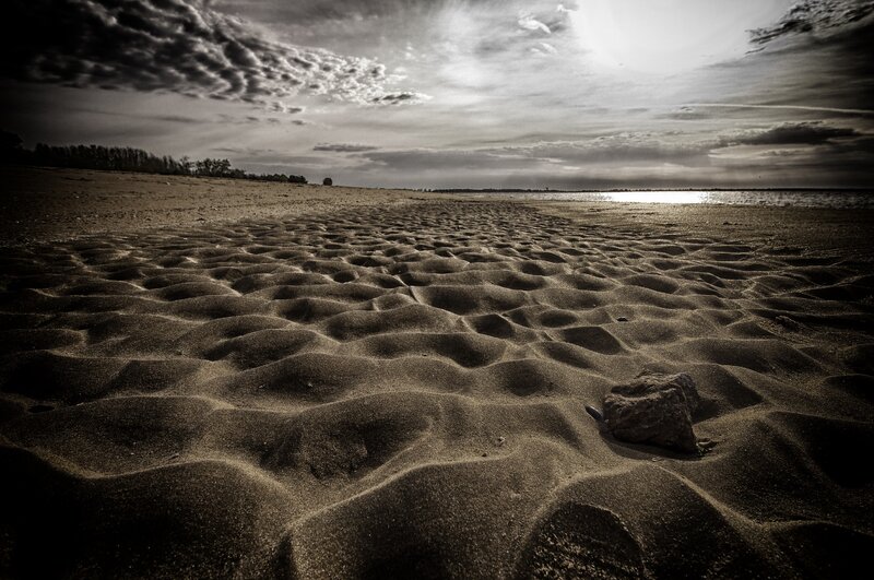 Deserted beach under cloudy sky