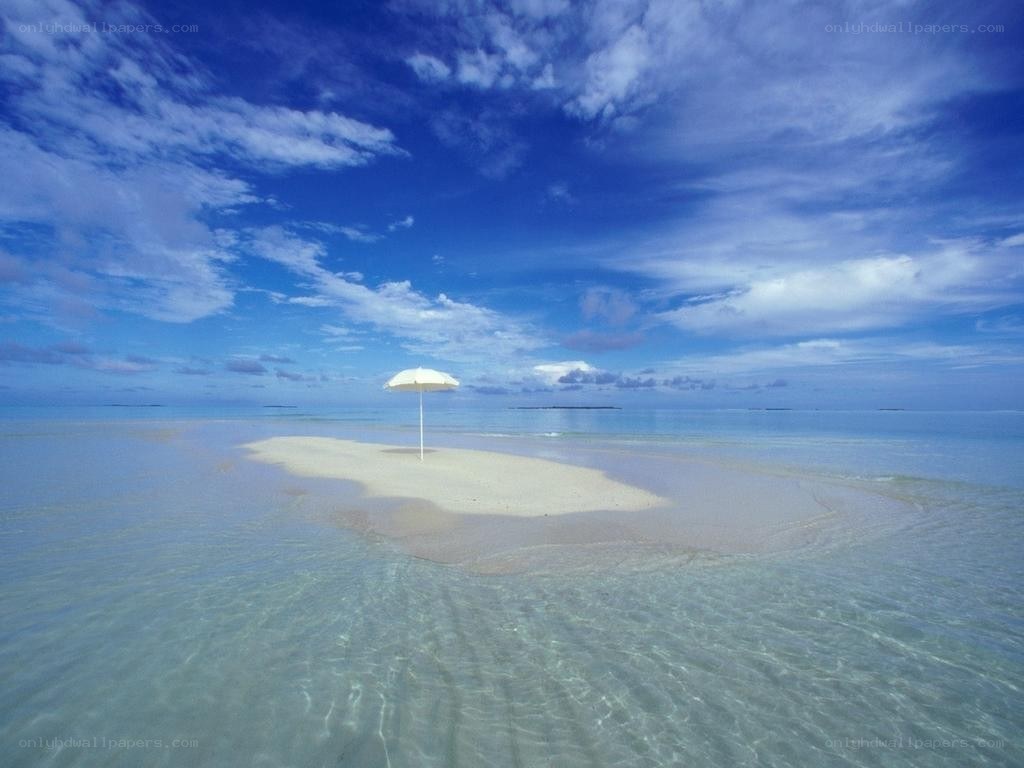 Deserted island with umbrella