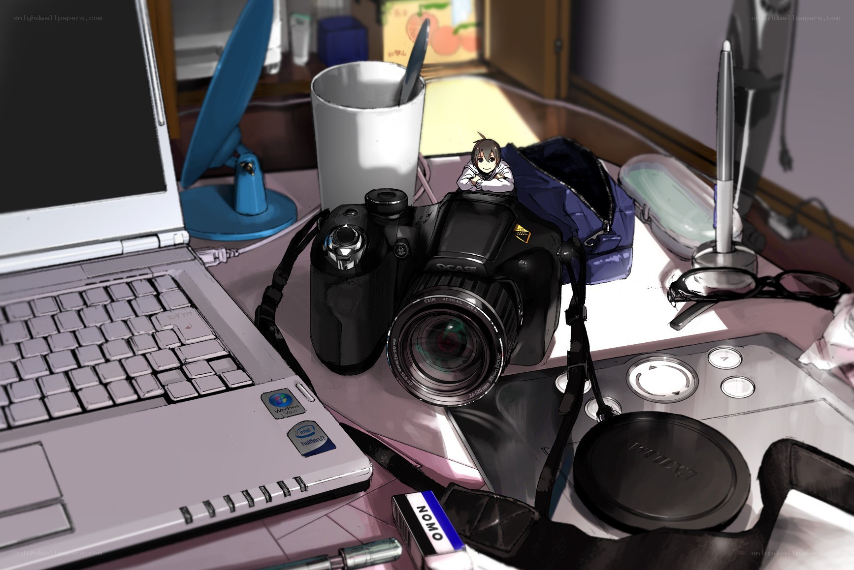 desk with camera and laptop