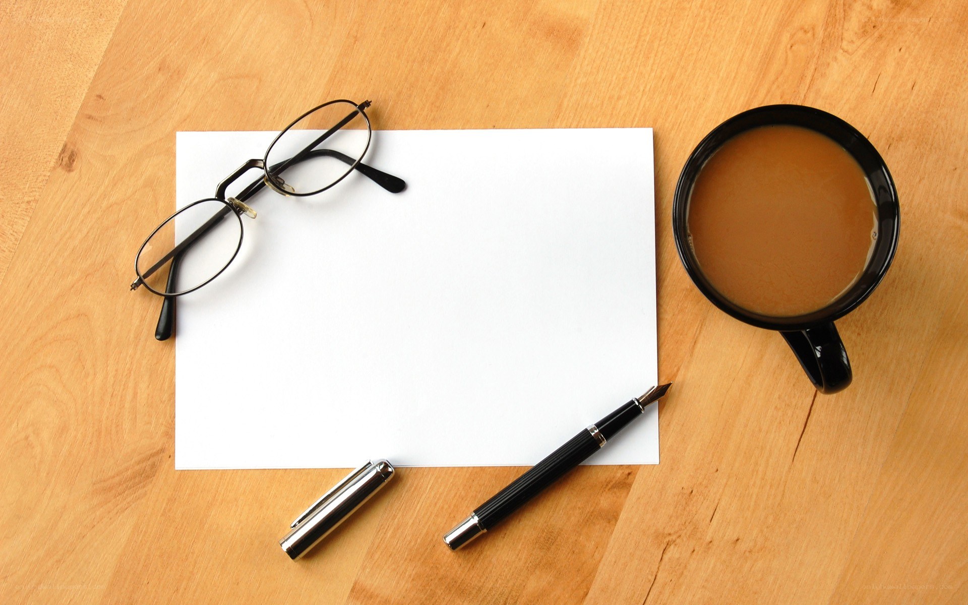 desk with coffee and writing tools
