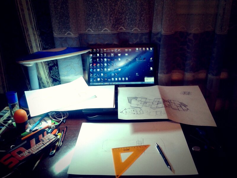 desk with laptop and drawings
