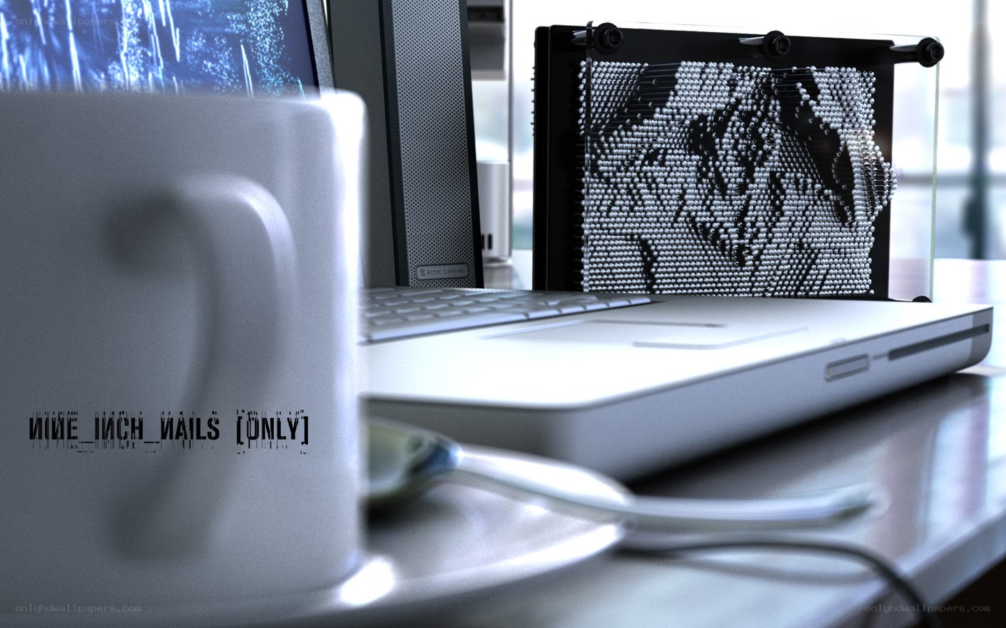 desk with laptop and pin art