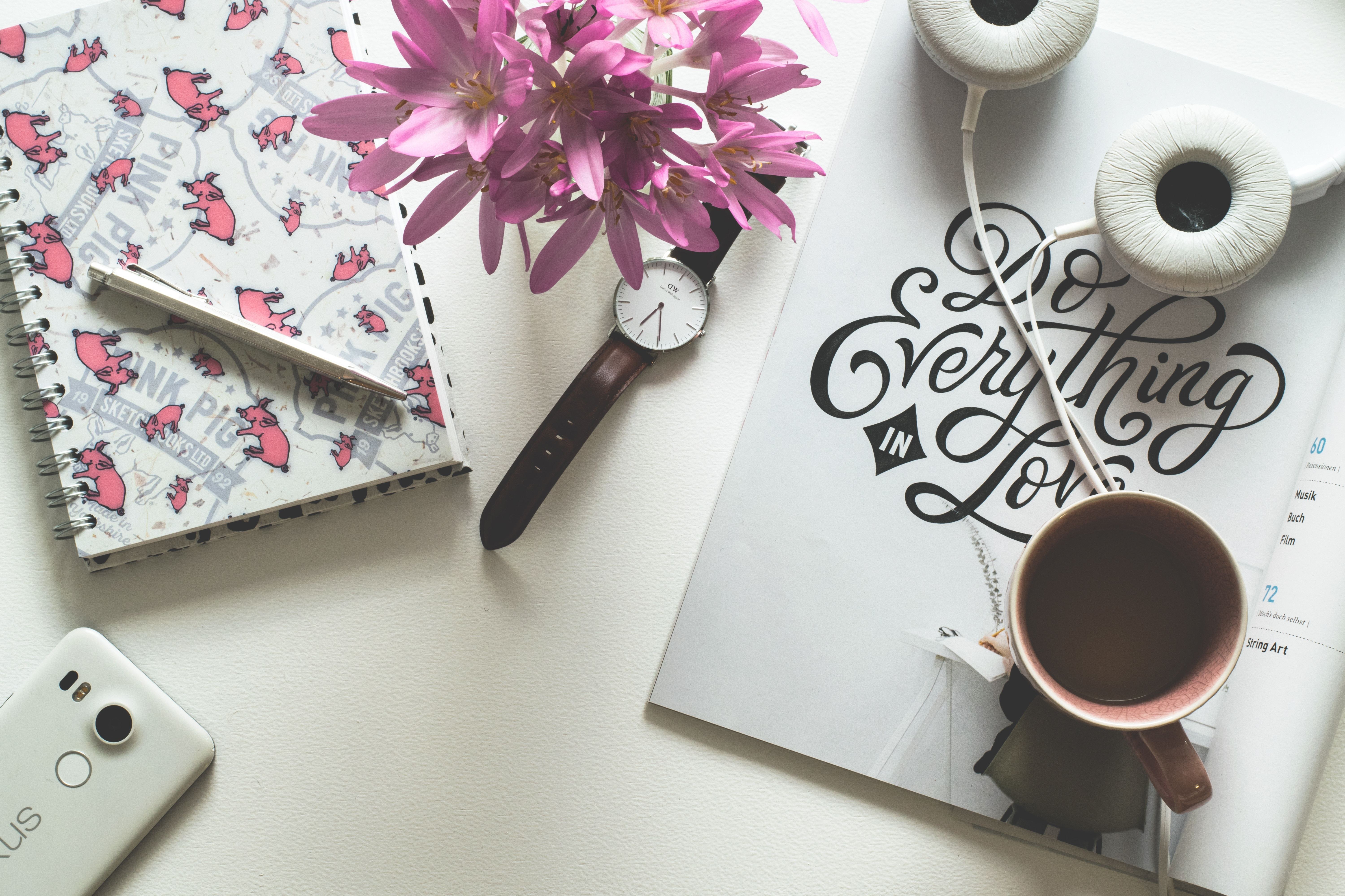 desk with notebook and flowers