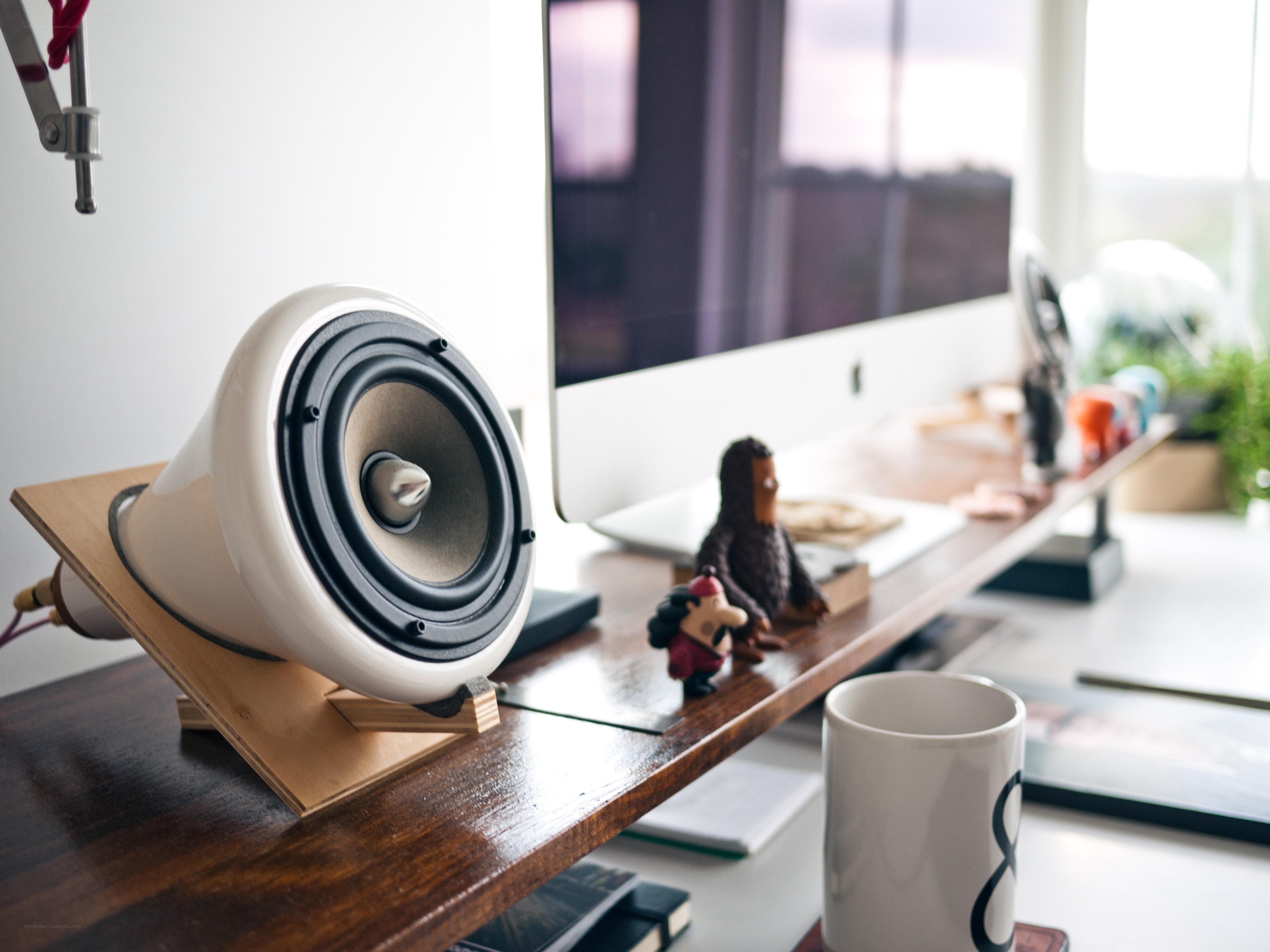 desk with speaker and figurines