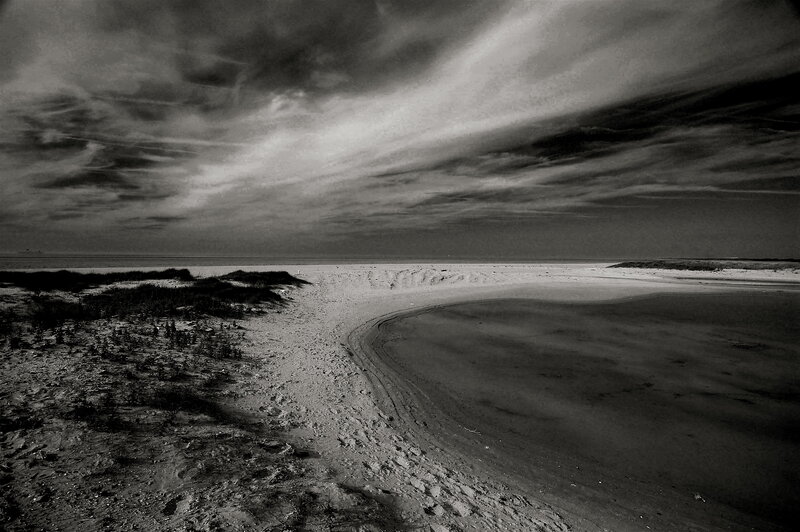 Desolate beach under cloudy sky