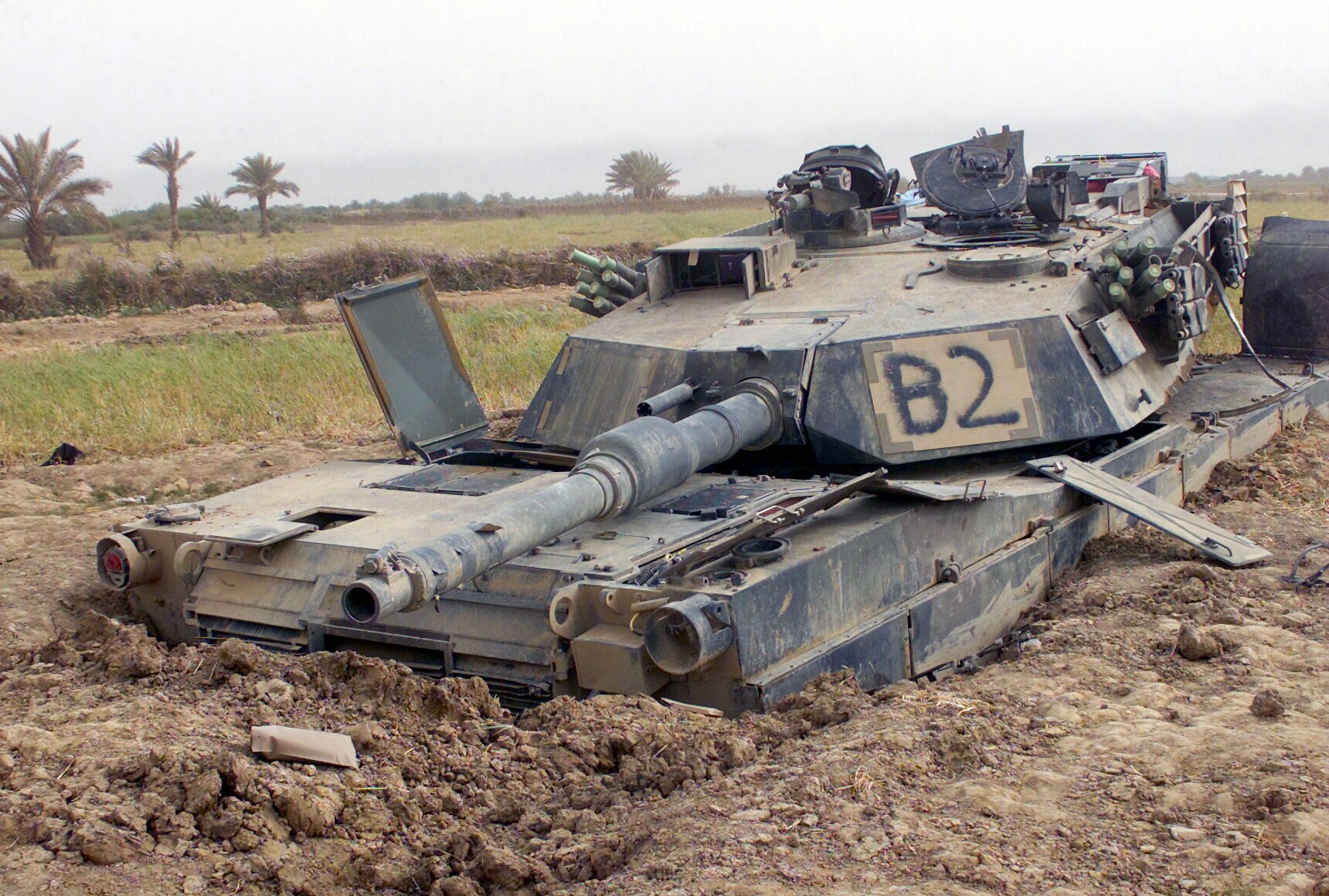 Destroyed tank in muddy field