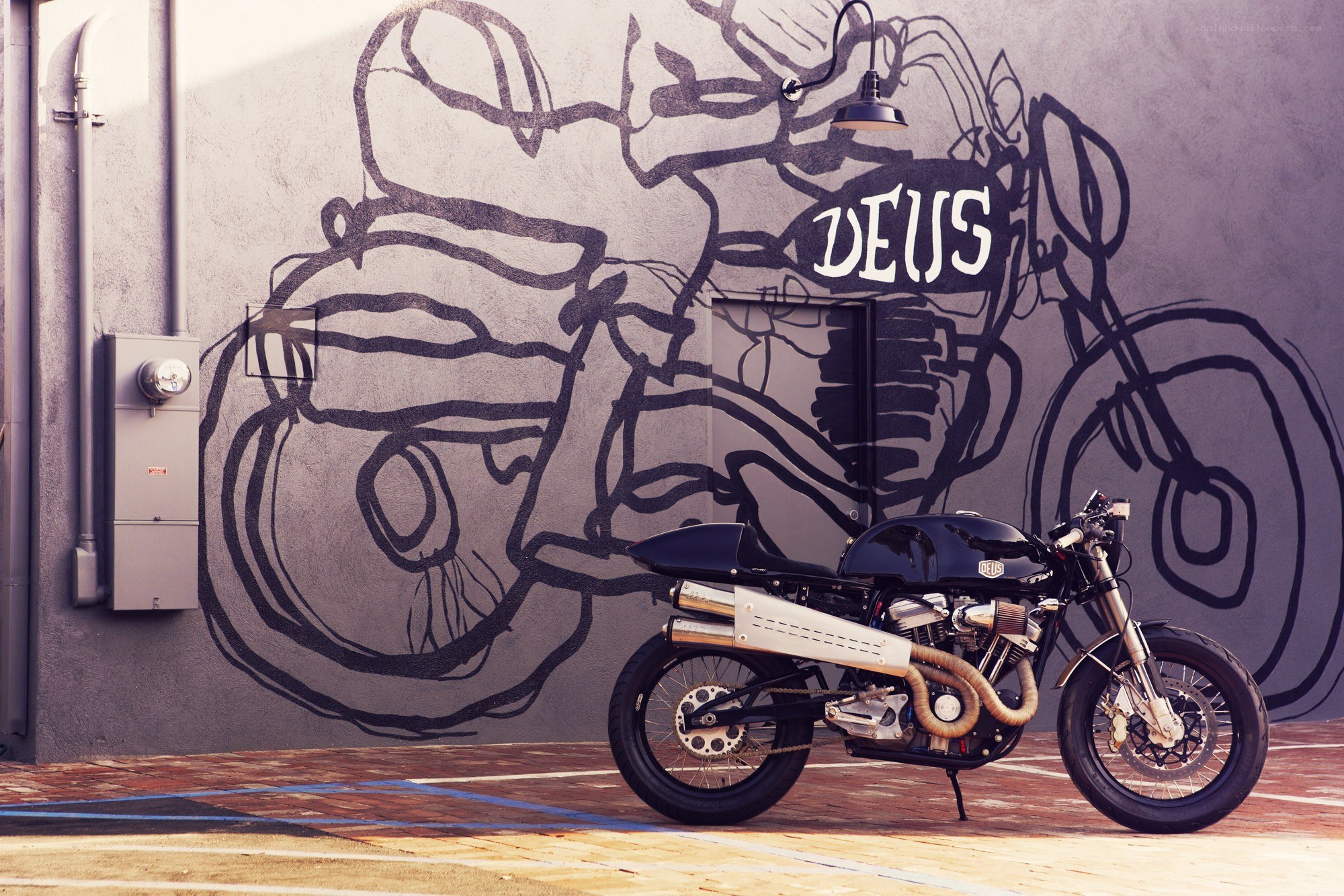 Deus motorcycle with mural backdrop