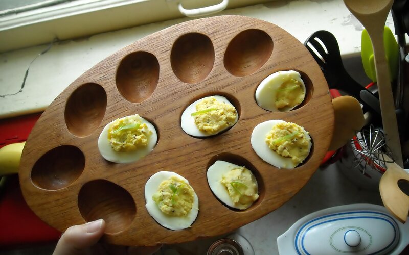 Deviled eggs on a wooden tray