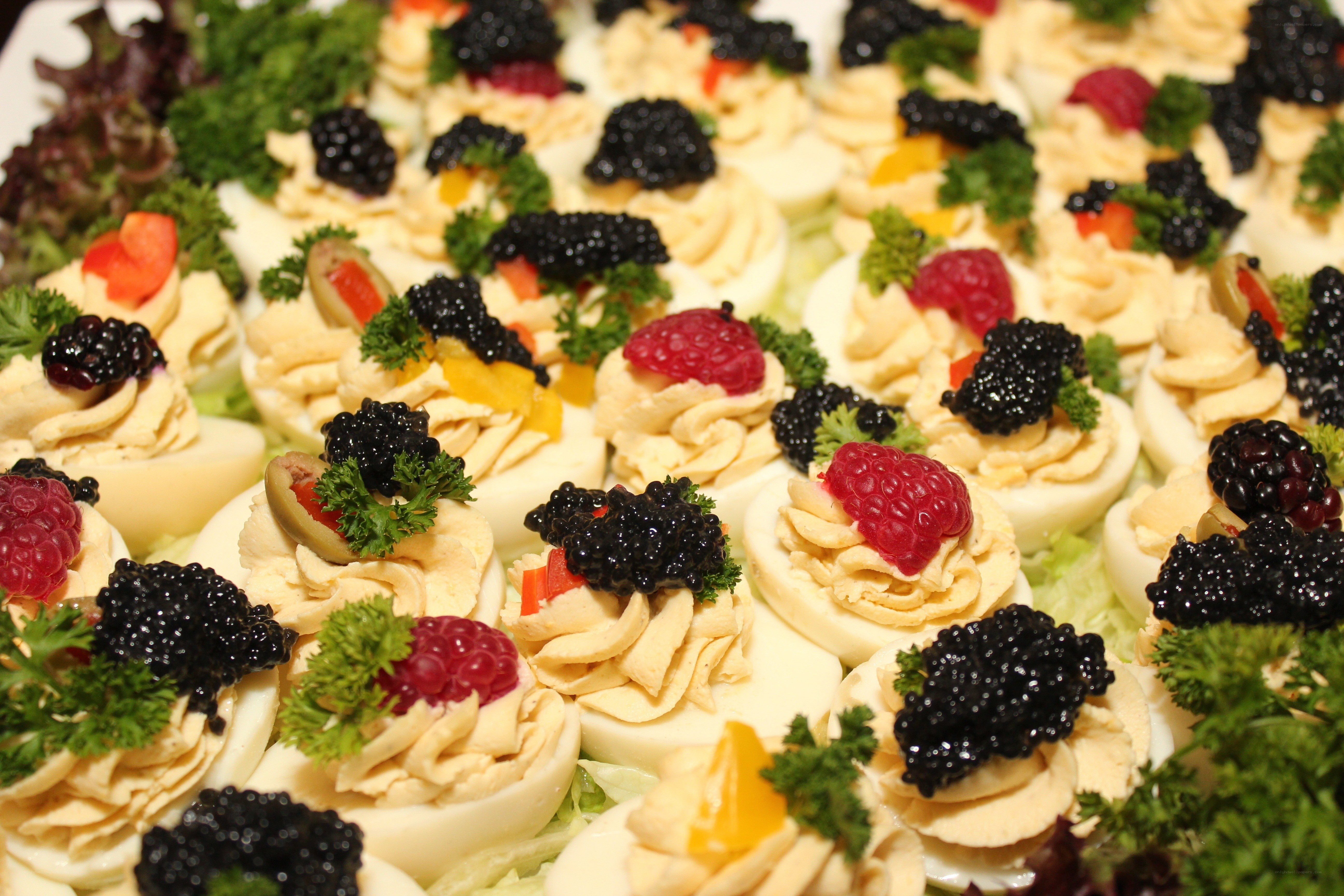 Deviled eggs with caviar and berries