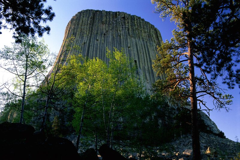Devils Tower Rock Formation — Blue, Dramatic, Afternoon, Photograph, Trees, Sky