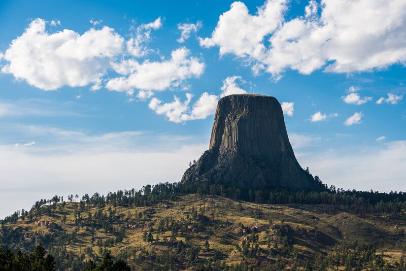 Devils Tower Rock Formation — Blue, Serene, Afternoon, Photograph, Trees