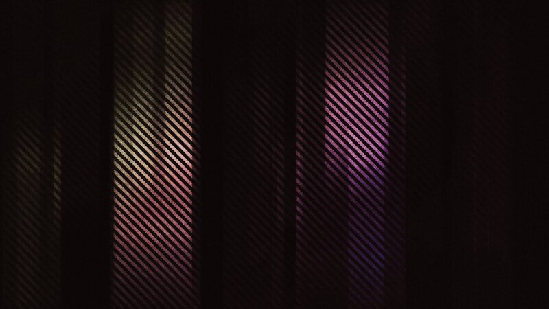 diagonal light patterns on dark surface