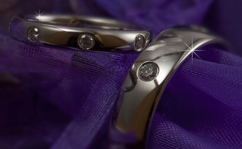 Diamond wedding rings on purple fabric