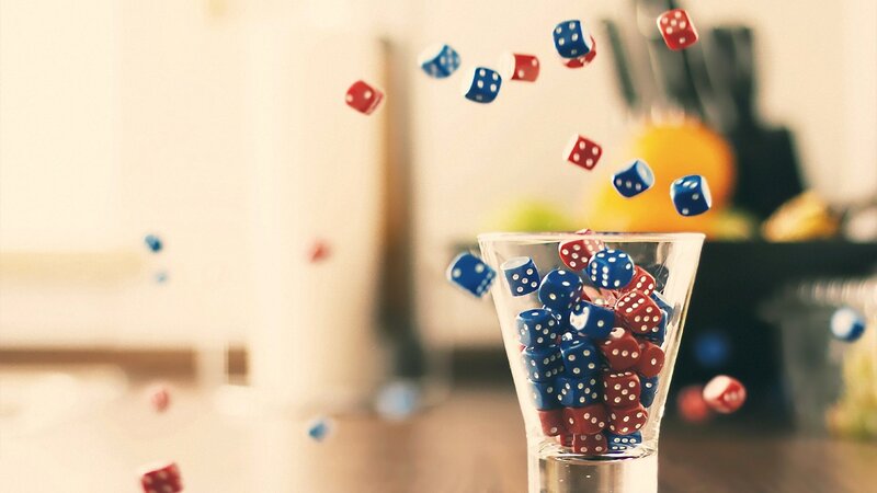 Dice falling into a glass