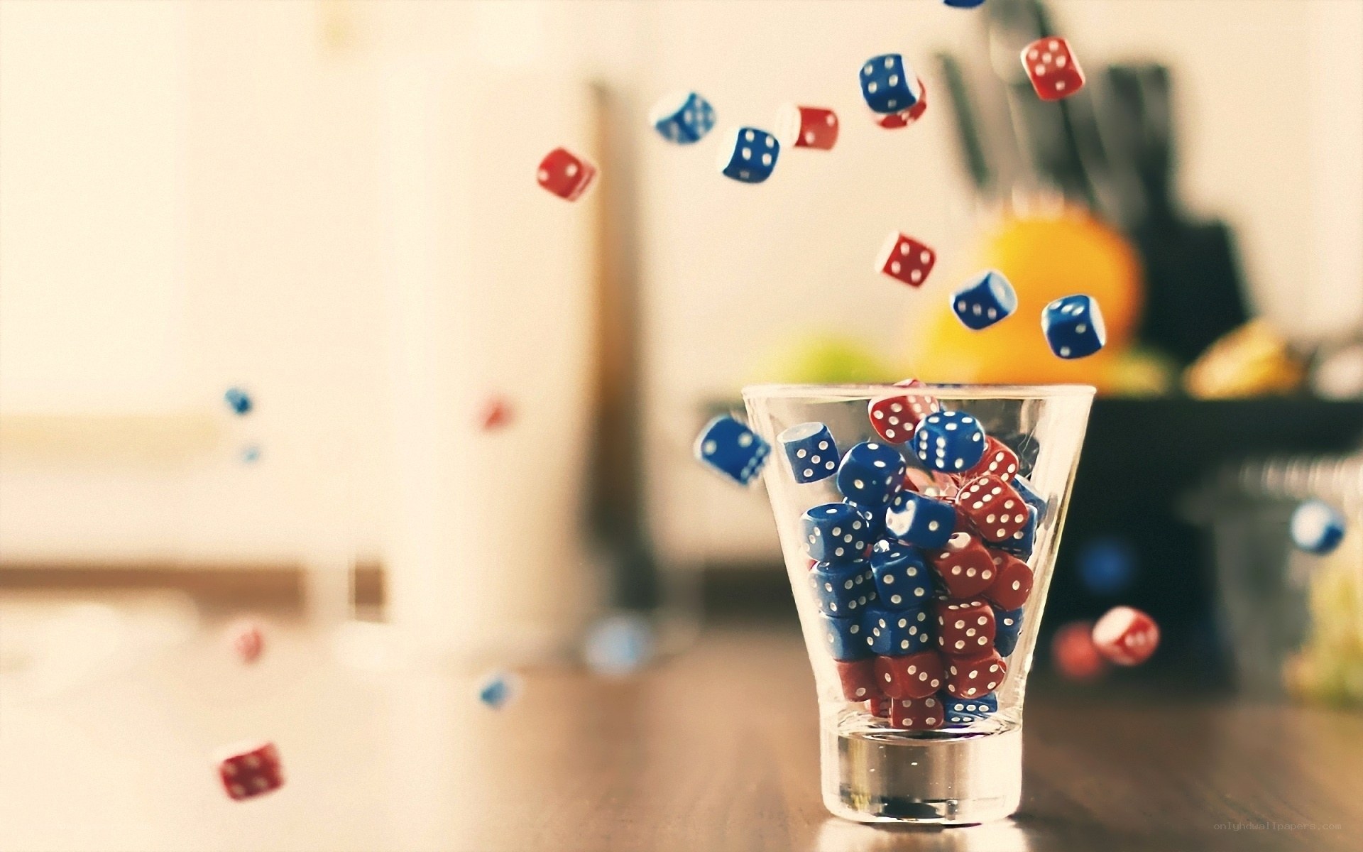 Dice falling into a glass