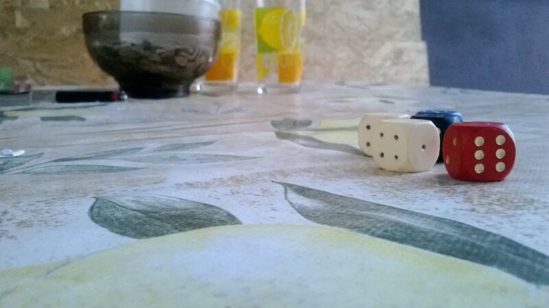 Dice on a table with drinks