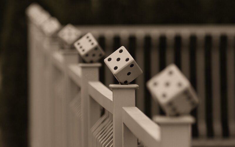 Dice on a white railing