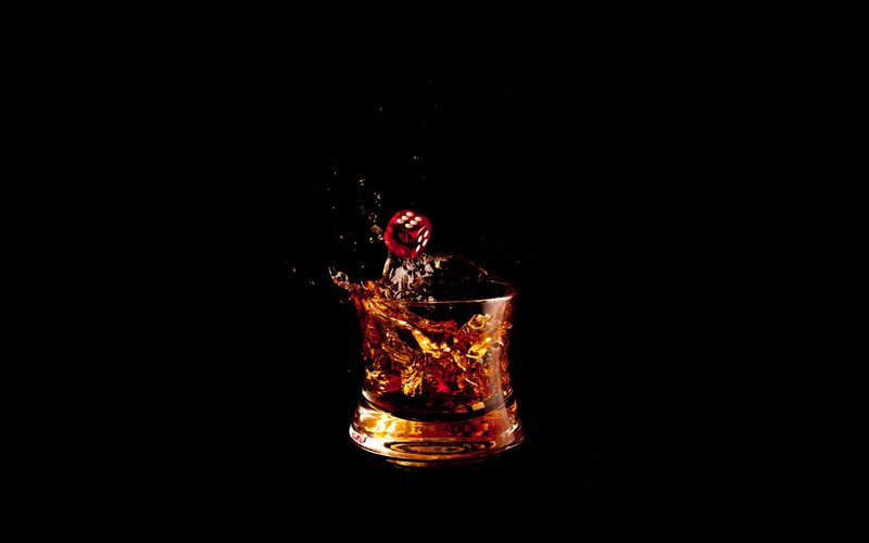 Dice splashing in whiskey