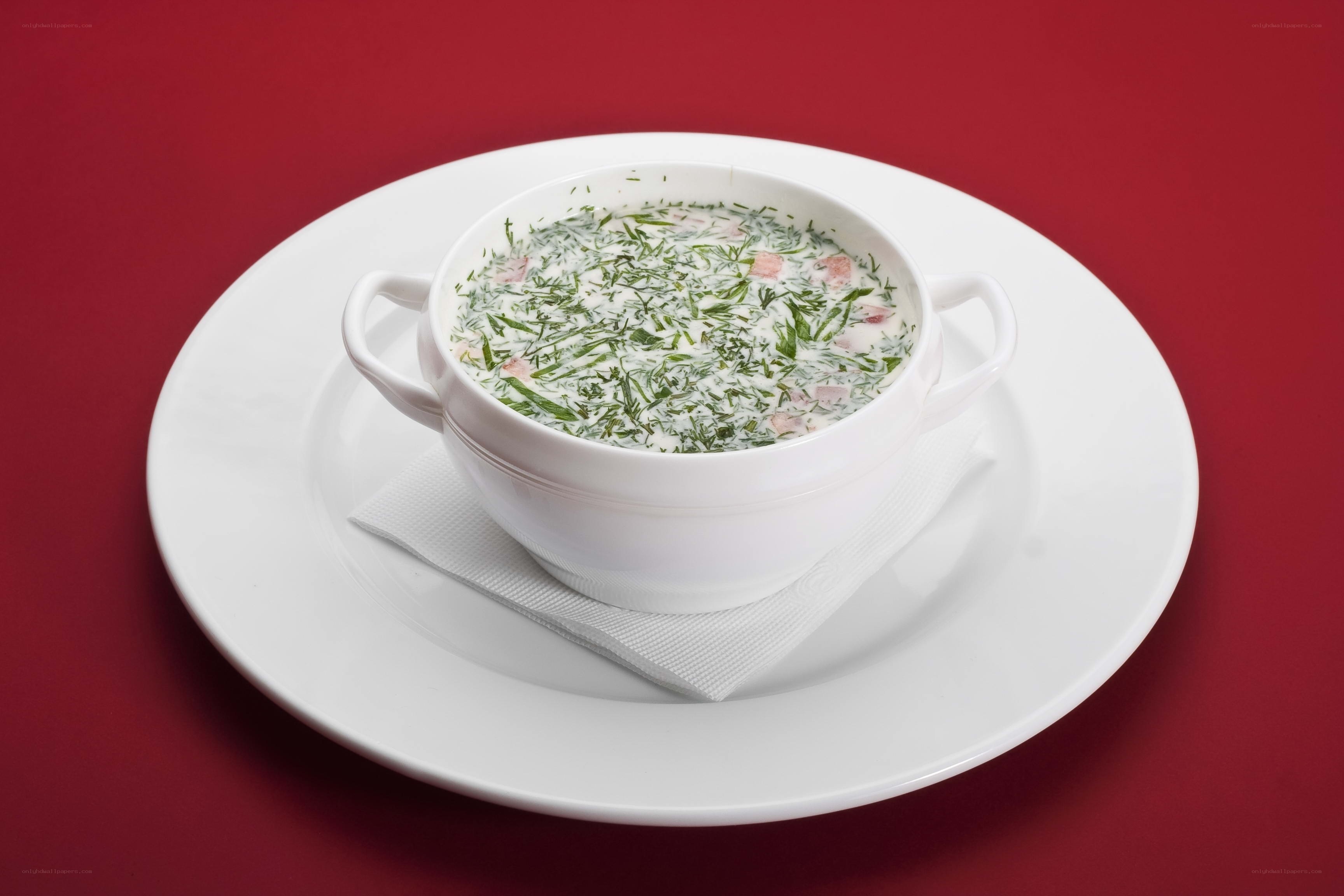dill soup in white bowl
